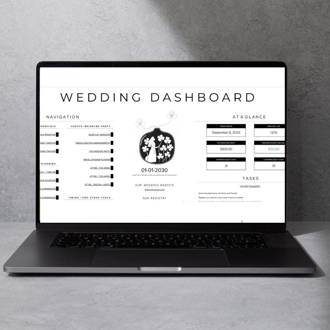 The Wedding Planner Dashboard from The Barefoot Edit - THE BAREFOOT EDIT Laptop on a gray surface displaying a wedding dashboard infographic titled 'WEDDING DASHBOARD' with sections for Navigation, At a Glance, and Tasks, plus a central illustration and dates.
